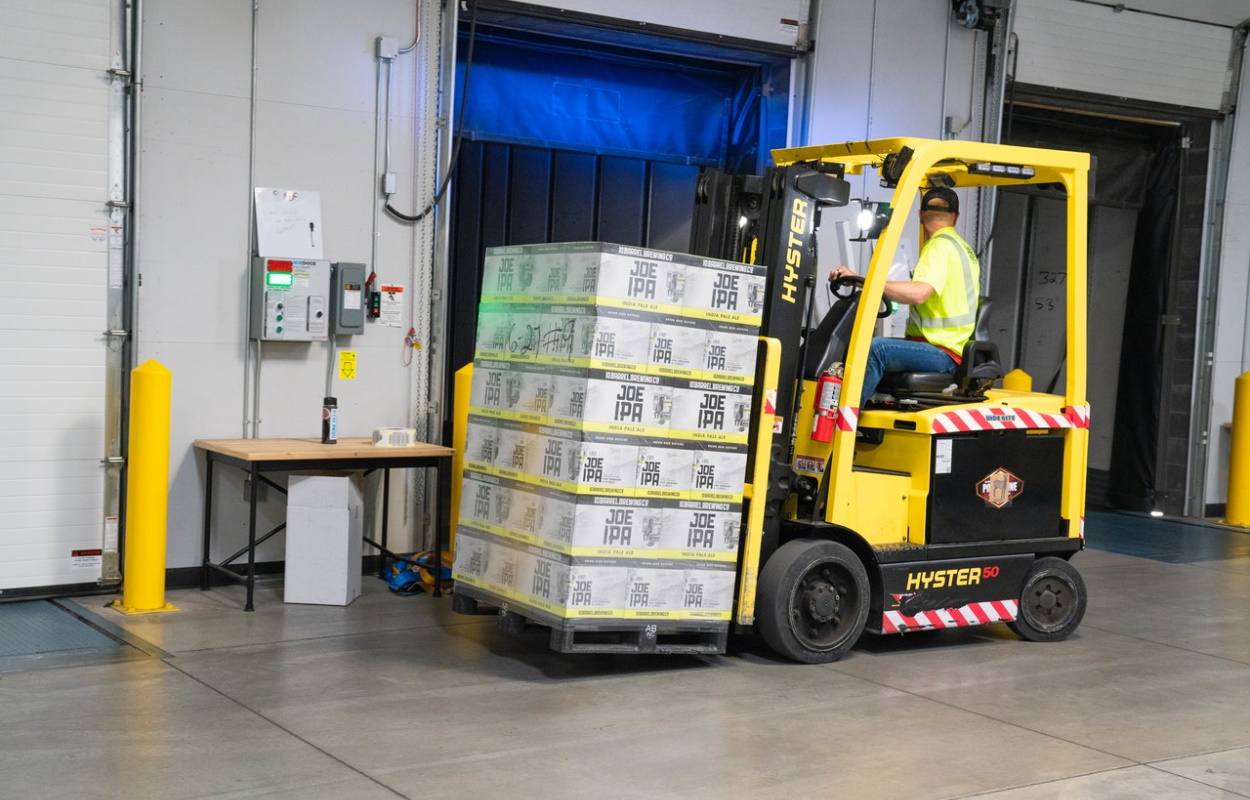 Man driving yellow fork lift